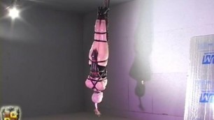 clear latex bondage doll suspended in belts