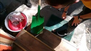 Big guy fixing wooden hole mug with shovel dildo