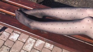 Slender legs in black pantyhose, foot fetish