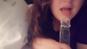 Girl sucks transparent dildo