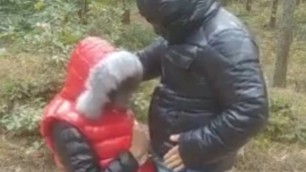 Fur hooded girl gives a handjob to a man wearing down