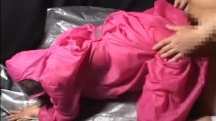 Japanese girl in pink plastic raincoat