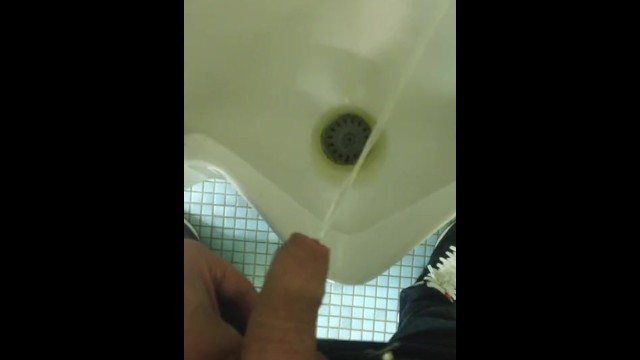 Pissing at the urinal with my uncut twink cock