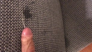 Piss on the couch from an erected uncut penis