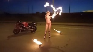 Naked girl tames fire on the street