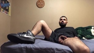 Naked stud in sneakers watches tv and cums a lot