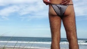 Sun Skin Guy changing thongs on public beach