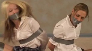 Two girls bound in tape in colege uniforms