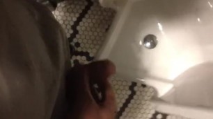 Pissing up a mirror in a restaurant bathroom