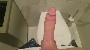 Wanking huge cock in public bathroom