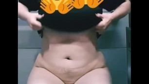 Chubby barely legal teen plays with her tits in a public bathroom at work.