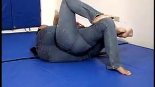 Two girls wrestling barefoot in jeans