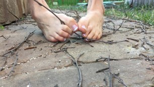 Hot young sexy teen crush small crispy sticks with bare feet at yard