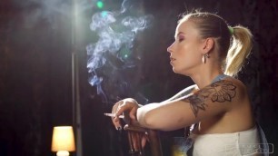 The hot blonde girl shows sexy side boobs and smokes a strong cigarette.