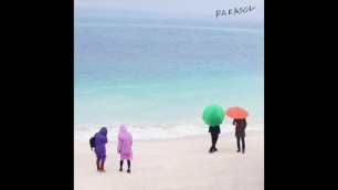 Korean Man Under Parasol On The Beach