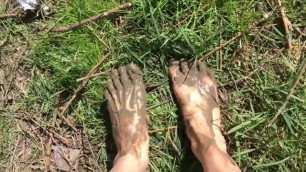 Hot sexy teen walking near the river, put feet in the mud