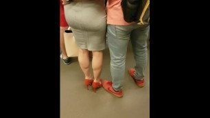 blonde with big calves in red heels walking in Subway Train