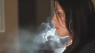 BEAUTIFUL BRUNETTE GIRL SMOKING AND USING HER LAPTOP COMPUTER HEAVY EXHALES