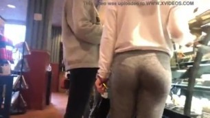 Candid teen in grey leggings at store