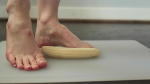 High arched sexy woman crushing banana with beautiful french pedicured feet