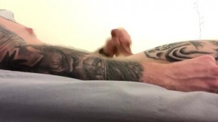 Tatted guy moans and clenches fist until he cums