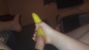 Guy uses a banana to jerk his cock.