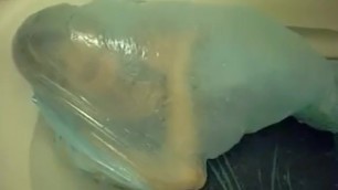 Plastic bag breathplay in bathtub