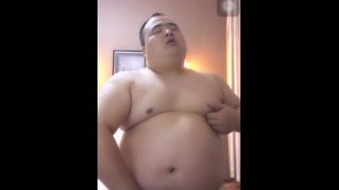 a chinese chubby trys to make his dick up