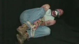 CG Dan bound and gagged in work boots and jeans.