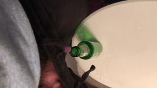 Desperate transman pissing in beer bottle with stp for relief - overflow