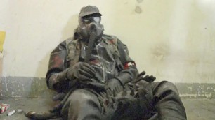 Rubbergay is wanking in a tube and smoking in a gasmask