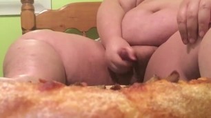 Chubby young gainer eats pizza with a special topping