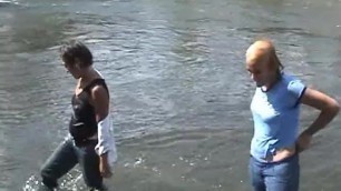 Girls enjoying swimming in their jeans.