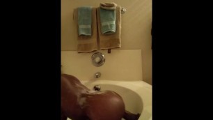 Ebony riding dildo in tub