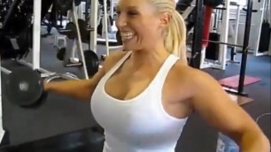 Woman with perfect big busty body grunts performing hard endurance circut