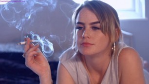 A girl smokes a cigarette, inhales huge amounts of smoke: Kick of nicotine!