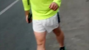 Young guy with huge cock walks commando in sports shorts