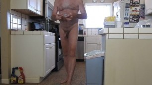 A naked daddy putting away groceries and playing with his penis.