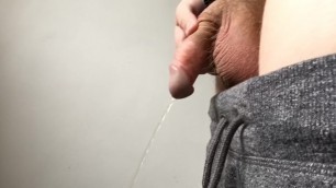 Thick dick teen pisses a hot stream and shakes wet dick aggressively