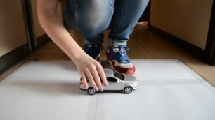 girl crushing a toy car