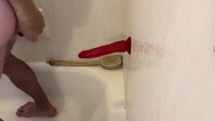 Riding red dildo in shower
