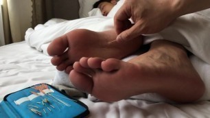 Sleeping boy feet being pricked