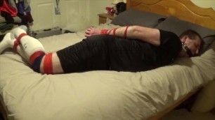 Man bound and gagged tight by a woman and struggling to get free