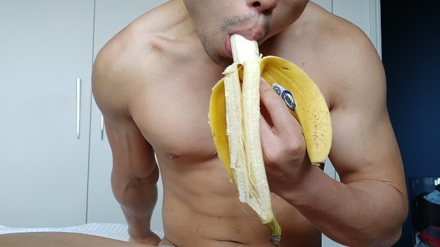 eating a banana - though not quite big enough for this flexing muscle hunk