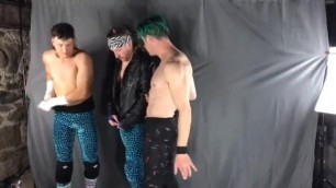 Three guys comparing abs during a photo shoot
