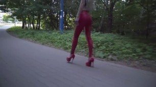 Blonde girl walking in RED leather leggings and high RED heels