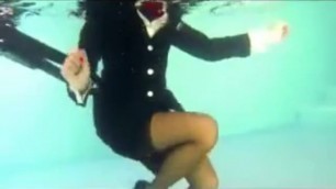 Girl swim underwater in air hostess uniform