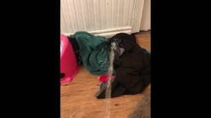 Pissing on a pile of clothes