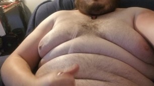 Chubby guy cums on himself.