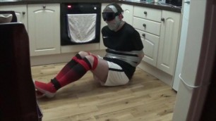 Footballer tied and taped tight on kitchen floor